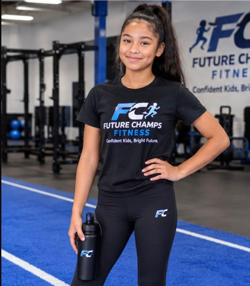 A girl in a Future Champs Fitness shirt holding a water bottle in the gym